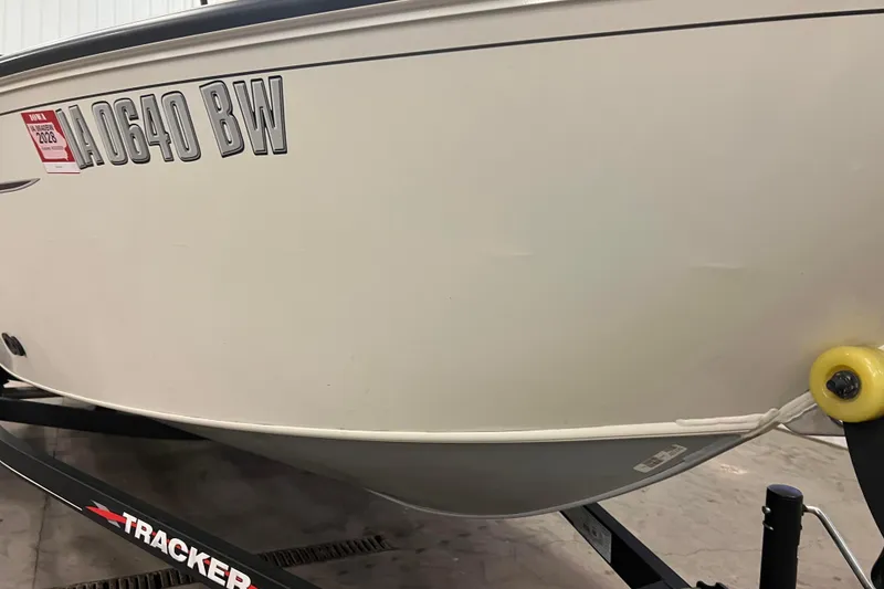 Slide: The Image of 2022 Tracker Pro Guide V-16 WT boat on trailer, registration visible. - 48