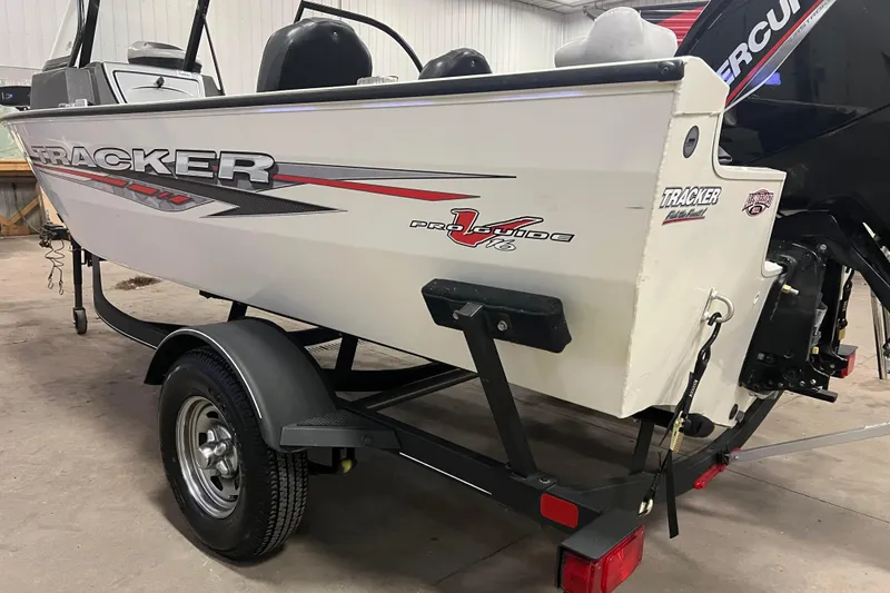 Slide: The Image of 2022 Tracker Pro Guide V-16 WT boat on trailer in garage setting. - 5