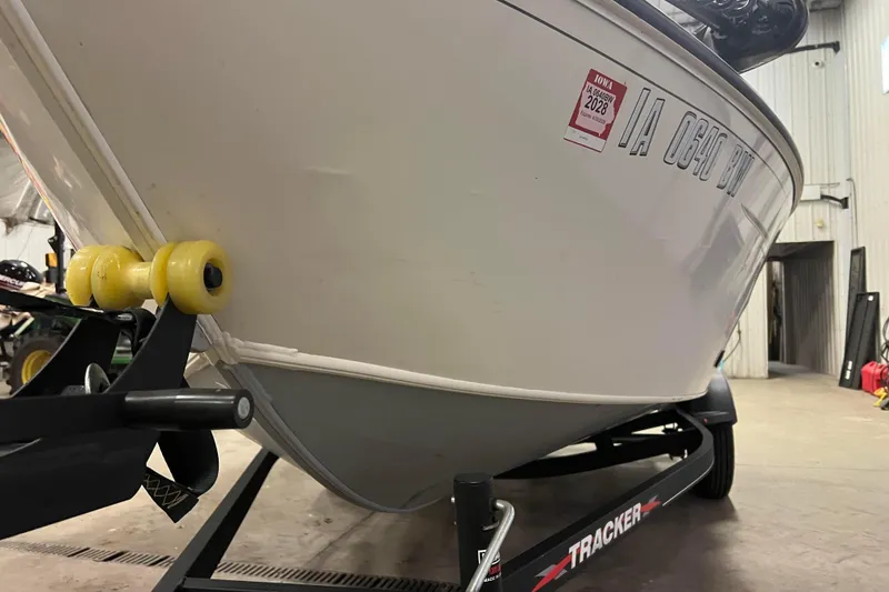 Slide: The Image of 2022 Tracker Pro Guide V-16 WT boat on trailer in indoor storage. - 50