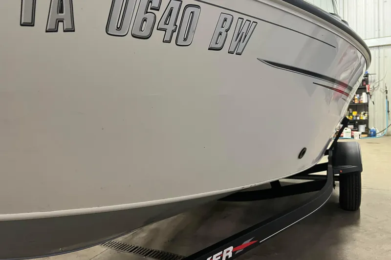Slide: The Image of 2022 Tracker Pro Guide V-16 WT boat on trailer in garage setting. - 51