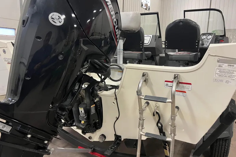 Slide: The Image of 2022 Tracker Pro Guide V-16 WT boat with Mercury outboard motor and ladder. - 55