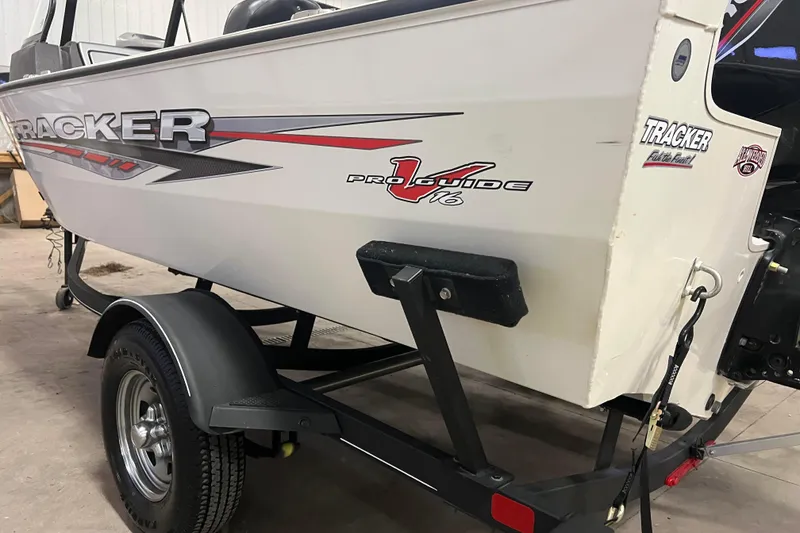 Slide: The Image of 2022 Tracker Pro Guide V-16 WT boat on trailer in garage setting. - 56