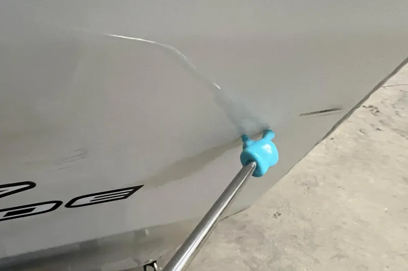 Slide: The Image of 2022 Tracker Pro Guide V-16 WT boat with a blue plug on the hull. - 57