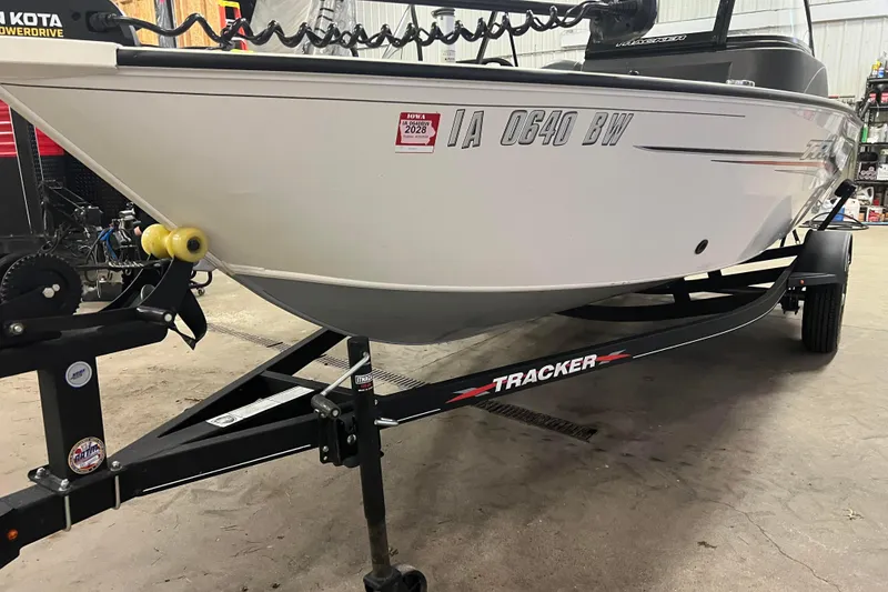 Slide: The Image of 2022 Tracker Pro Guide V-16 WT boat on trailer in garage setting. - 6