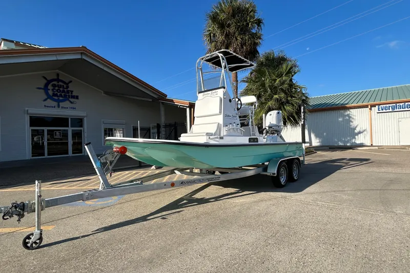 Slide: The Image of 2026 Shallow Stalker CAT 211 PRO boat on trailer outside Gulf Coast Marine. - 1