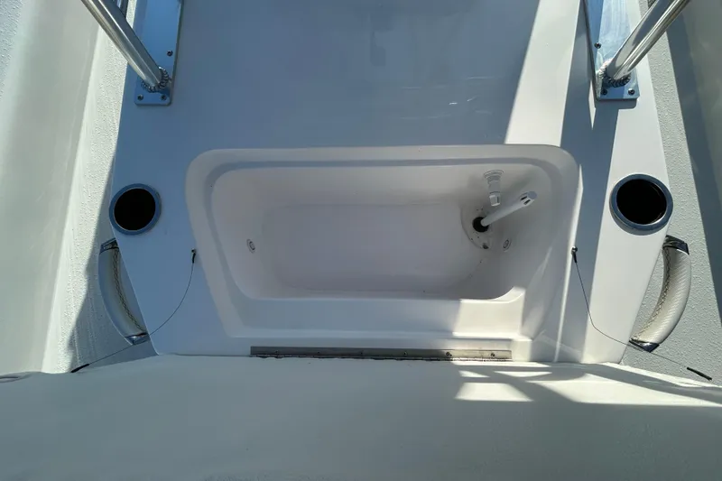 Slide: The Image of Shallow Stalker CAT 211 PRO 2026 boat interior with storage compartment and cup holders. - 10