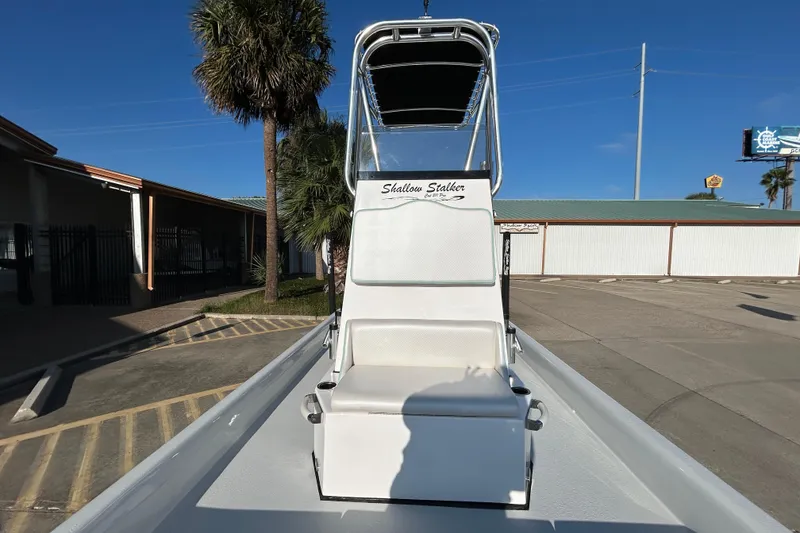 Slide: The Image of 2026 Shallow Stalker CAT 211 PRO boat with center console in a sunny outdoor setting. - 18