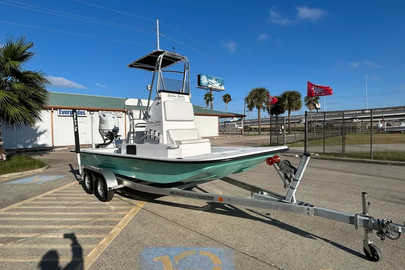Slide: The Image of 2026 Shallow Stalker CAT 211 PRO boat on trailer, parked outdoors under blue sky. - 3