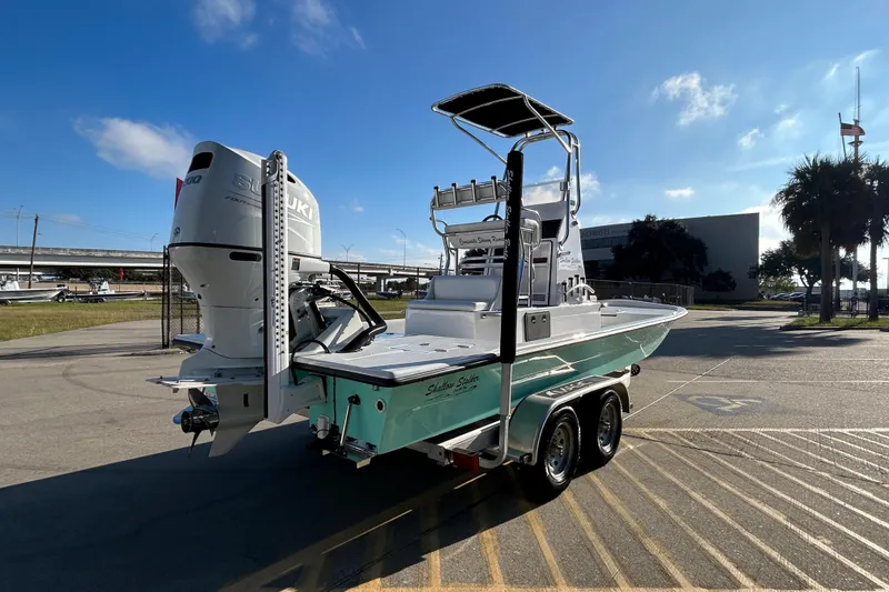 Slide: The Image of 2026 Shallow Stalker CAT 211 PRO boat with Suzuki engine, parked on a trailer. - 5