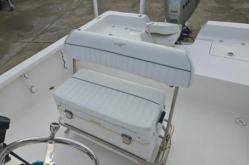 Slide: The Image of 2011 Tidewater 2400 Bay Max boat interior with white seating and steering wheel. - 12