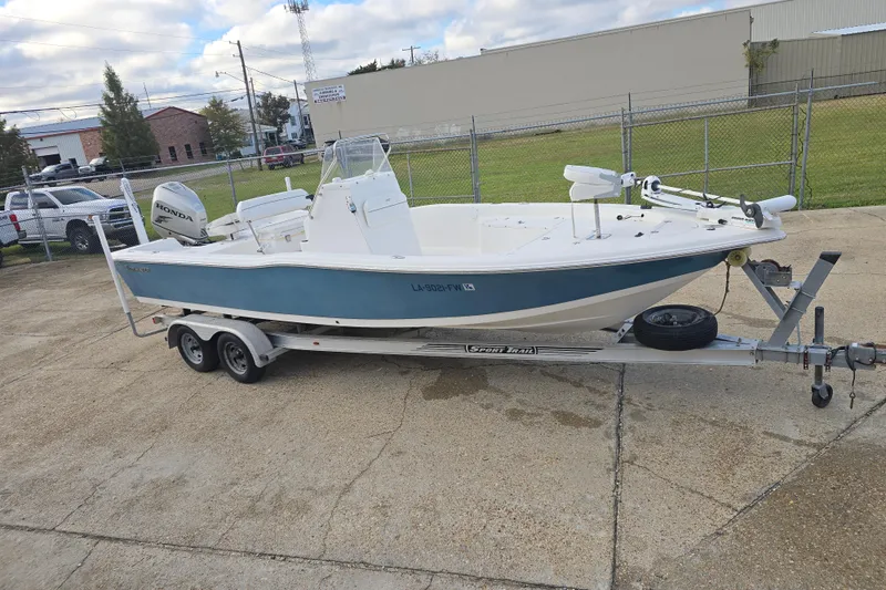 Slide: The Image of 2011 Tidewater 2400 Bay Max boat on trailer, parked outdoors. - 2