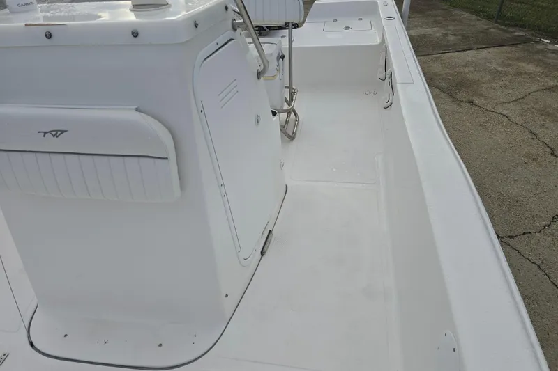 Slide: The Image of 2011 Tidewater 2400 Bay Max boat interior, featuring white deck and seating area. - 20