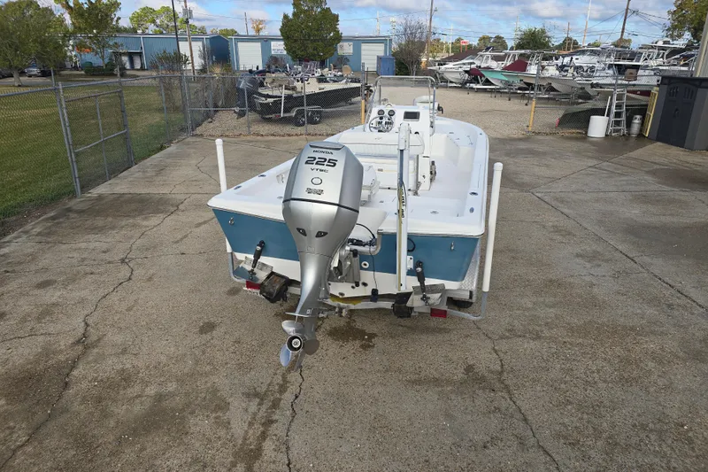 Slide: The Image of 2011 Tidewater 2400 Bay Max boat with Honda 225 VTEC engine in a marina setting. - 5