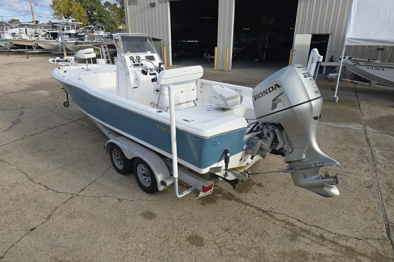 Slide: The Image of 2011 Tidewater 2400 Bay Max boat with Honda outboard motor on a trailer. - 6
