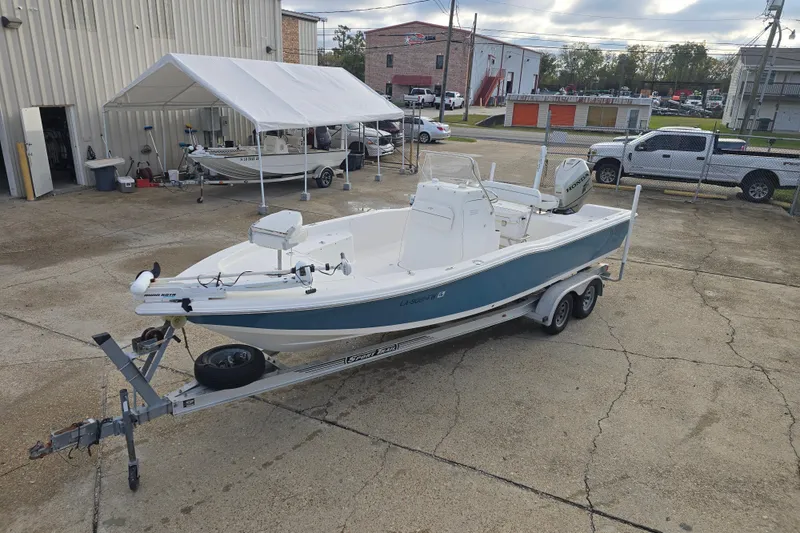 Slide: The Image of 2011 Tidewater 2400 Bay Max boat on trailer in parking lot. - 8
