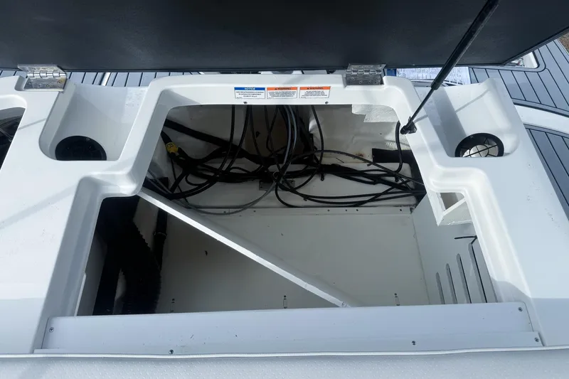 Slide: The Image of Open storage compartment of 2021 Sea Ray SPX 190 Outboard boat, showing internal wiring. - 11