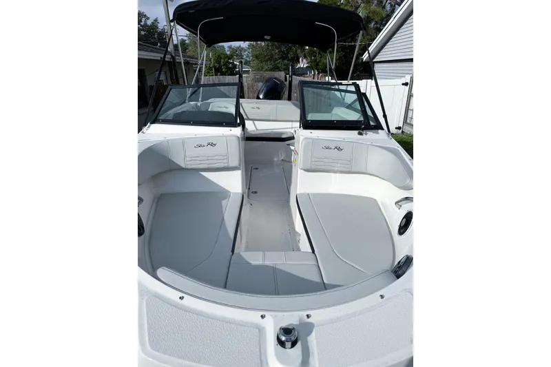 Slide: The Image of 2021 Sea Ray SPX 190 Outboard boat interior with seating and canopy. - 4