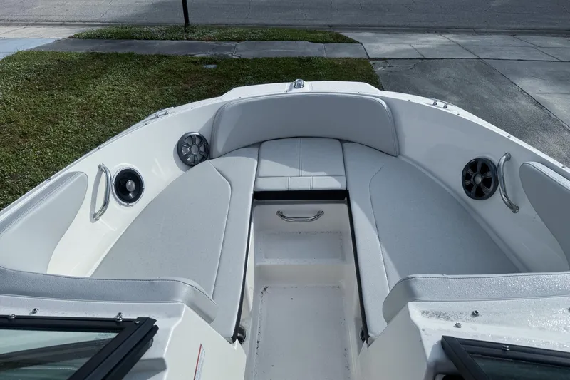 Slide: The Image of 2021 Sea Ray SPX 190 Outboard boat interior with cushioned seating and speakers. - 5