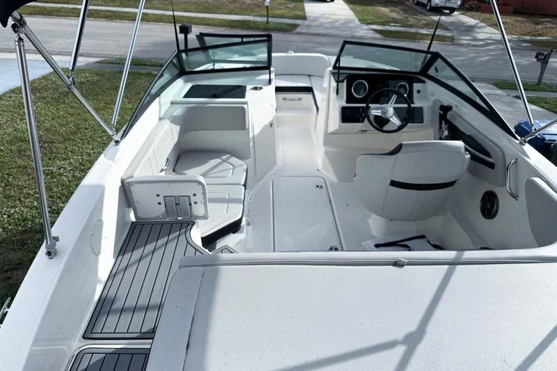 Slide: The Image of 2021 Sea Ray SPX 190 Outboard boat interior with seating and steering console. - 6