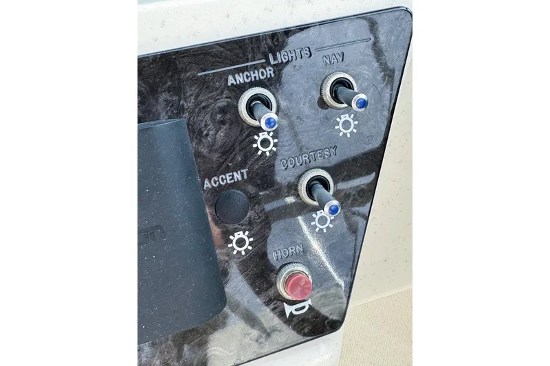 Slide: The Image of Control panel of 2021 Sea Ray SPX 190 Outboard with switches for lights and horn. - 8