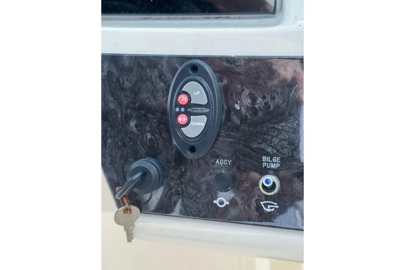 Slide: The Image of Control panel of 2021 Sea Ray SPX 190 Outboard with key and bilge pump switch. - 9