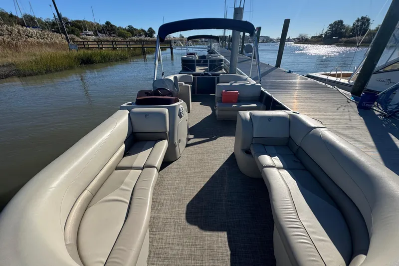 Slide: The Image of 2023 Cypress Cay Seabreeze 232 pontoon boat docked, featuring spacious seating and sleek design. - 3
