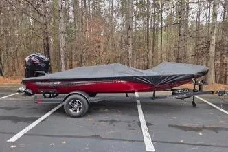 Slide: The Image of 2023 Ranger RT188C boat with cover in wooded parking area. - 3
