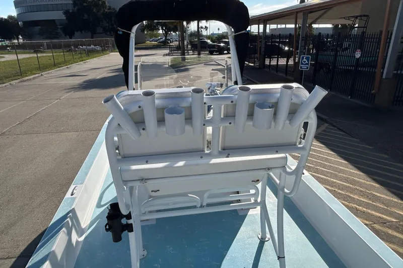 Slide: The Image of 2016 Shallow Sport 21 Sport boat with rod holders, parked on a sunny day. - 10