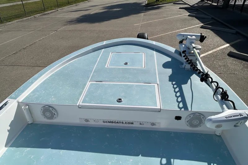 Slide: The Image of 2016 Shallow Sport 21 Sport boat deck with storage compartments and trolling motor. - 13