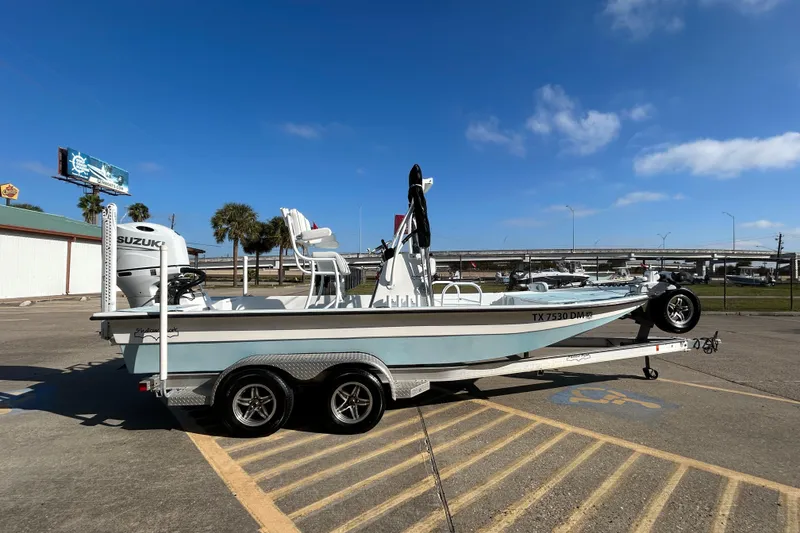 Slide: The Image of 2016 Shallow Sport 21 Sport boat on trailer, parked in sunny lot. - 5