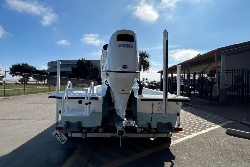 Slide: The Image of 2016 Shallow Sport 21 Sport boat with 200 HP engine, parked outdoors. - 7