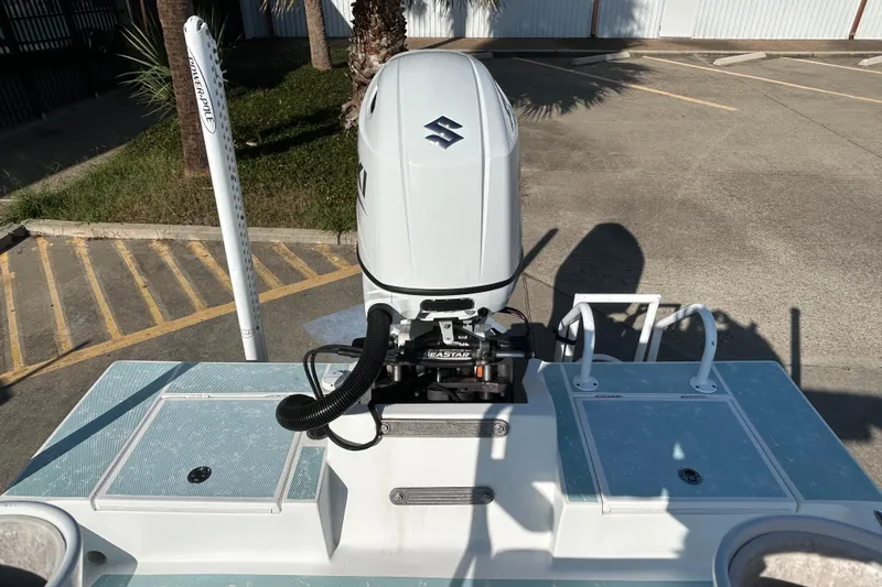 Slide: The Image of 2016 Shallow Sport 21 Sport boat with Suzuki outboard motor, parked on concrete. - 9
