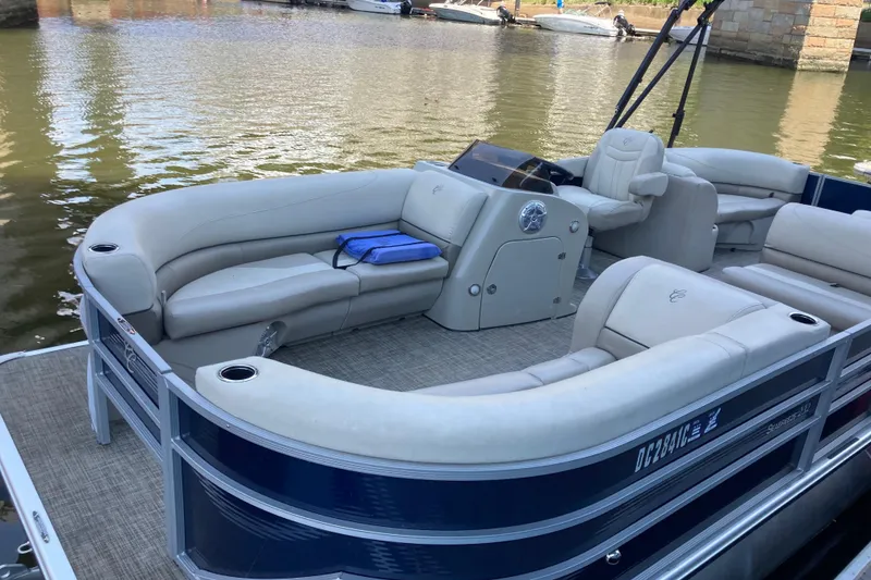 Slide: The Image of 2023 Cypress Cay Seabreeze 232 pontoon boat with spacious seating on calm water. - 3