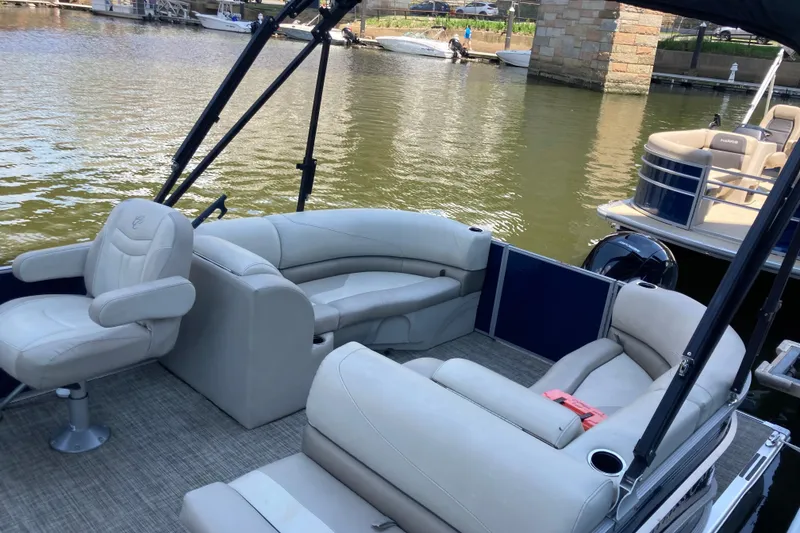 Slide: The Image of 2023 Cypress Cay Seabreeze 232 pontoon boat with spacious seating and scenic water view. - 5