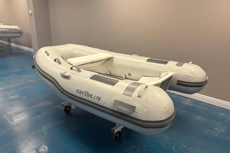 Slide: The Image of Inflatable Caribe L-8 dinghy, 2025 model, displayed indoors with plants and promotional signage. - 3