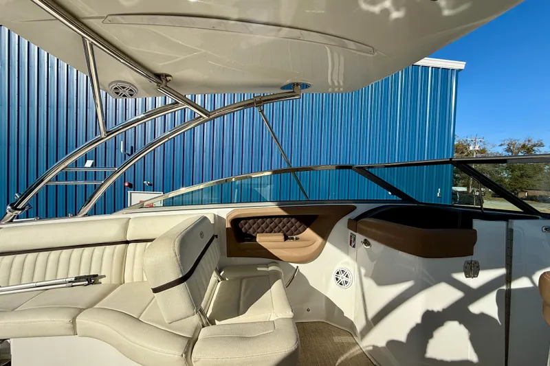 Slide: The Image of Interior of a 2018 Cobalt R35 boat with beige seating and blue exterior. - 11