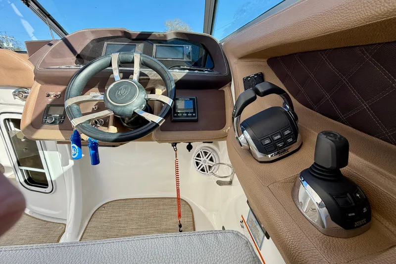 Slide: The Image of 2018 Cobalt R35 boat cockpit with steering wheel, controls, and dashboard. - 12