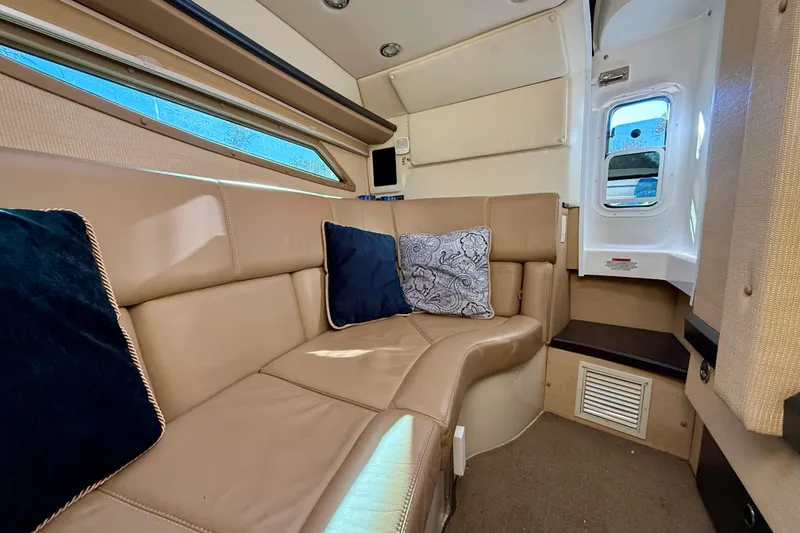 Slide: The Image of Luxurious interior of 2018 Cobalt R35 boat with beige seating and decorative pillows. - 16