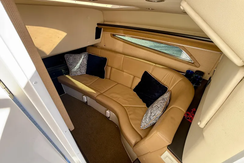 Slide: The Image of Luxurious interior of 2018 Cobalt R35 boat with tan leather seating and decorative pillows. - 17