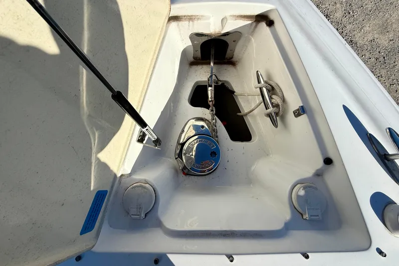 Slide: The Image of 2018 Cobalt R35 boat anchor compartment with winch and rope. - 23