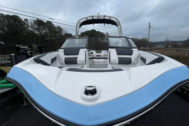 Slide: The Image of 2025 Yamaha Boats 195S with sleek design and comfortable seating, parked outdoors. - 12
