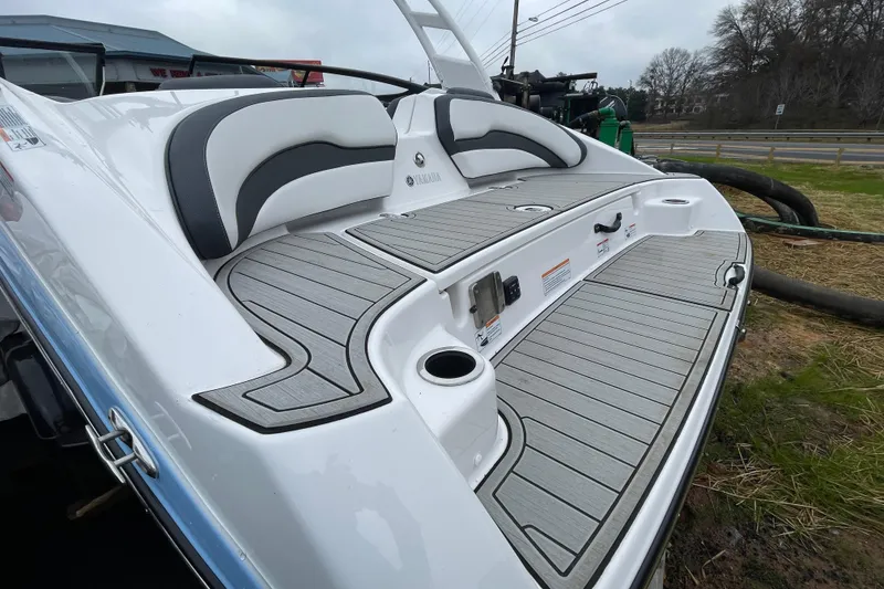 Slide: The Image of 2025 Yamaha Boats 195S swim platform with cushioned seating and sleek design. - 14