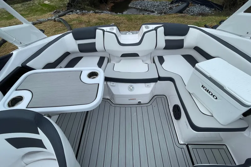 Slide: The Image of 2025 Yamaha Boats 195S interior with seating, table, and cooler on deck. - 16