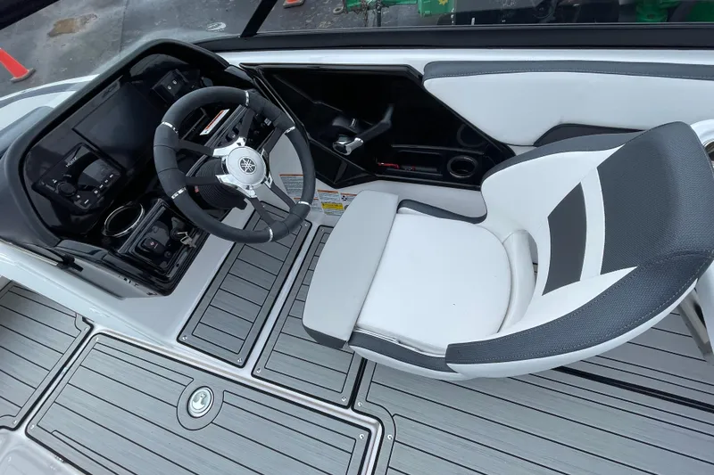 Slide: The Image of 2025 Yamaha Boats 195S cockpit with steering wheel and modern seating design. - 6