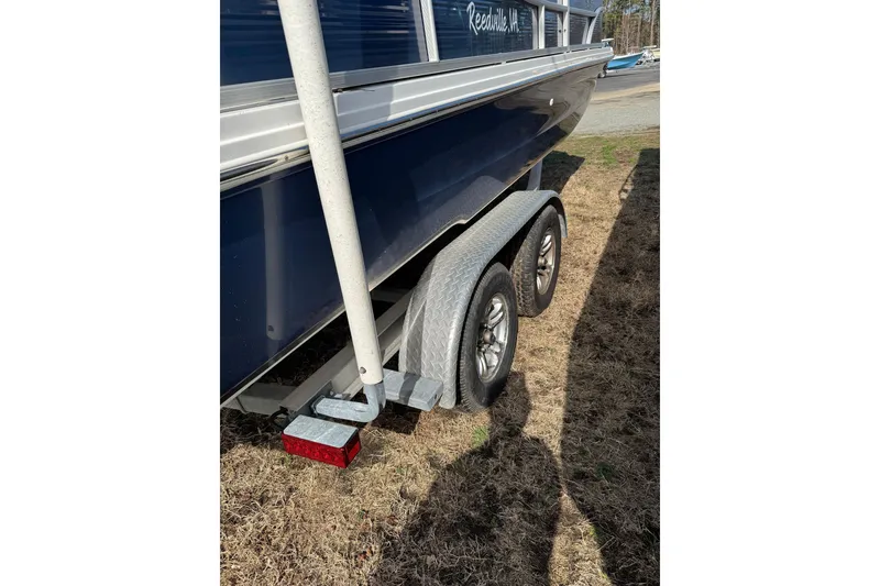 Slide: The Image of 2022 Hurricane FunDeck 1960 RE boat on trailer, side view in outdoor setting. - 14