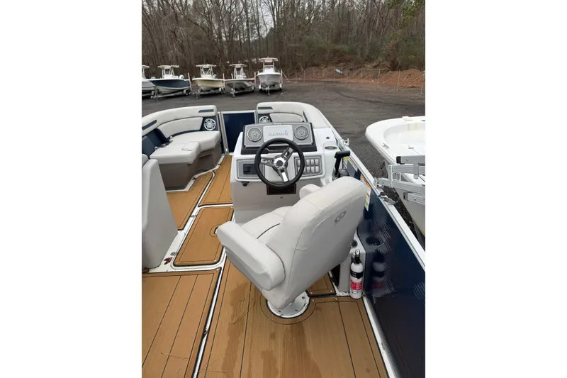 Slide: The Image of 2022 Hurricane FunDeck 1960 RE boat interior with steering wheel and seating. - 3