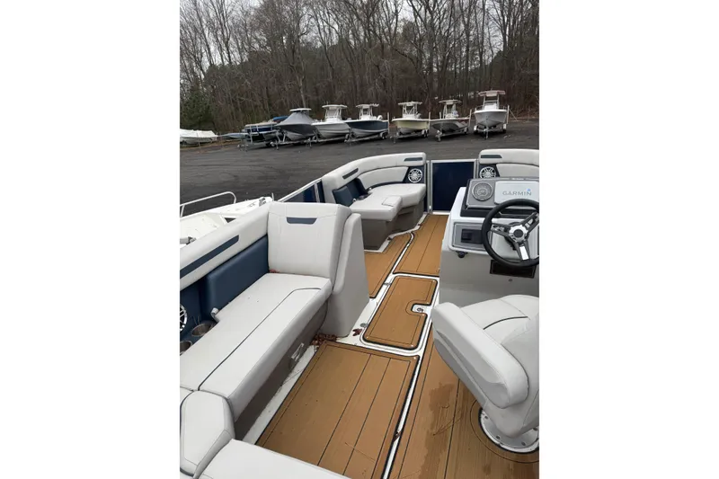 Slide: The Image of 2022 Hurricane FunDeck 1960 RE interior with seating and steering wheel, parked outdoors. - 5