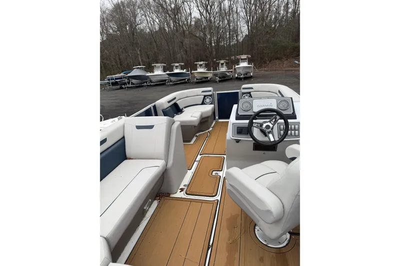 Slide: The Image of 2022 Hurricane FunDeck 1960 RE interior with white seating and wood-style flooring. - 6