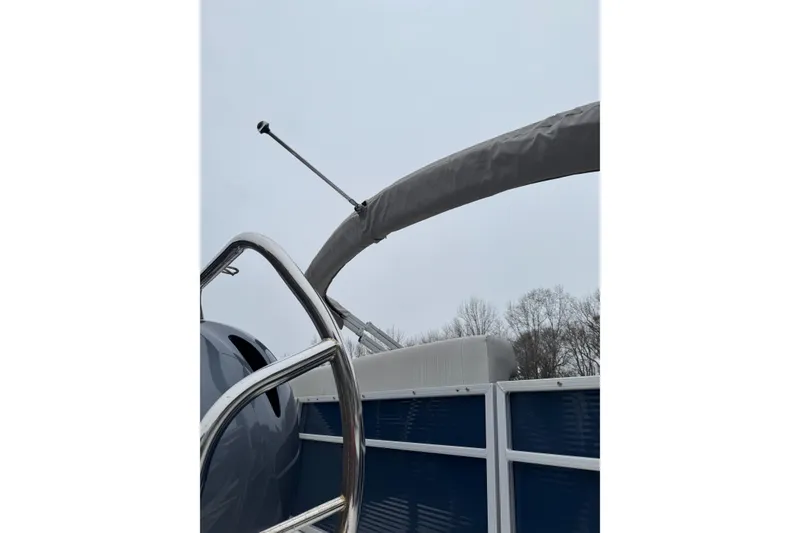 Slide: The Image of 2022 Hurricane FunDeck 1960 RE boat with canopy and railing, overcast sky background. - 7