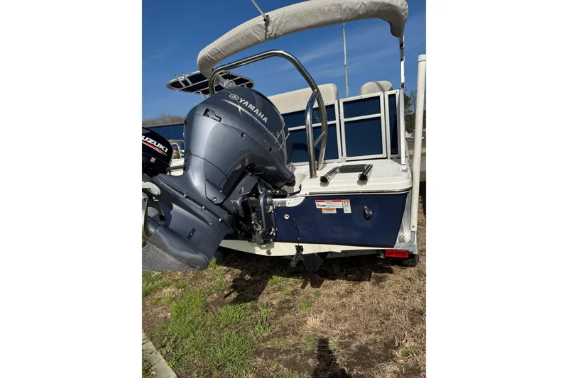Slide: The Image of 2022 Hurricane FunDeck 1960 RE boat with Yamaha outboard motor, parked on grass. - 9